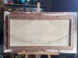 painting on easel in a room with a lot of stuff on the floor