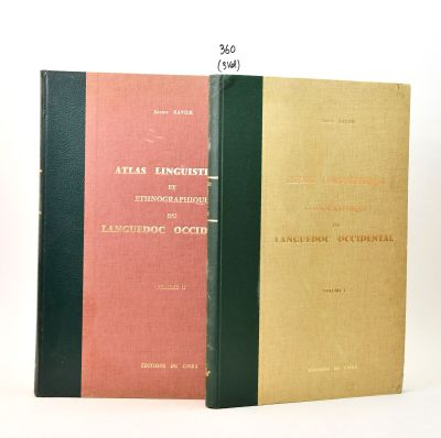 three books are stacked on top of each other on a white surface