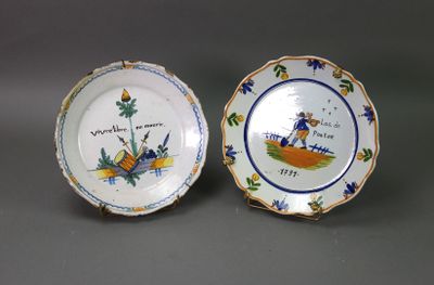two small plates with designs on them sitting on a table