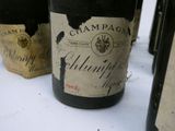 several bottles of wine are lined up on a table