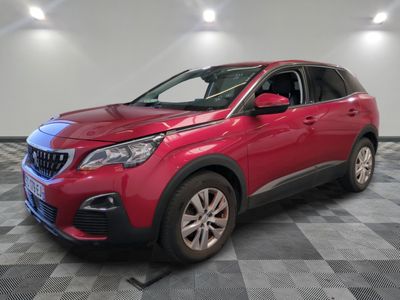 a red car is parked in a room with a checkered floor