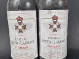 two bottles of wine sitting next to each other on top of a table
