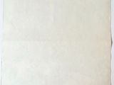 an old piece of paper sitting on top of a white surface