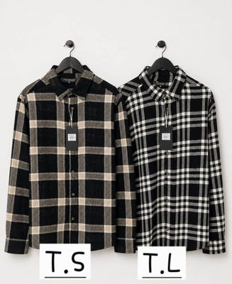 two men ' s shirts hanging on a hanger on a wall
