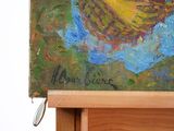 a picture of a painting of a woman on a easel