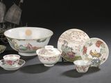 many different types of porcelain dishes and bowls on the table