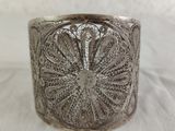 a close up of a silver bracelet on a white surface