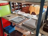 many plates and pans on the shelves in the kitchen