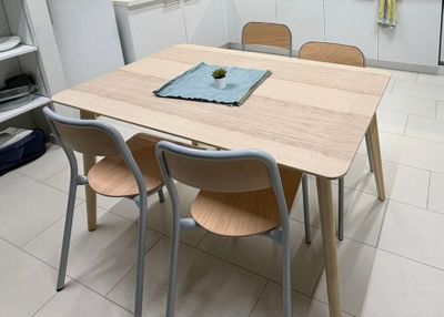 four chairs around a table in a small kitchen