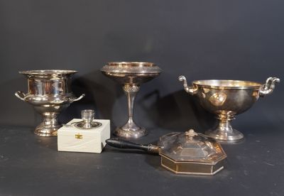 trois tasses en argent et une petite boîte posées sur une table