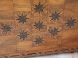 a wooden chest with stars on it on a marble floor