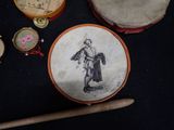 a drum, drum stick, and other musical instruments on a table