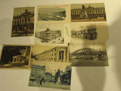 several old postcards of different buildings and buildings on a table