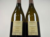 pair of two bottles of wine sitting next to each other on a white surface