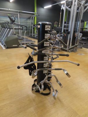 a gym with a lot of machines on the floor