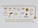an assortment of gold and silver jewelry including rings, necklaces, and earrings