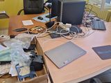 a desk with a laptop, monitor, and other electronics on it