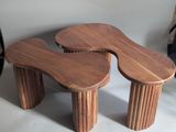 two wooden stools that are sitting on a table
