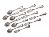 a lot of spoons and forks on a white surface