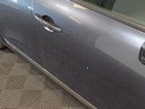 a car that has been painted silver and has a hole in the door