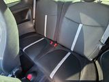 the back seats of a car with a red seat belt