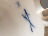 a close up of a vase with a bird on it