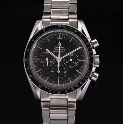 a close up of a watch with a black face on a black background