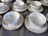 a lot of cups and saucers on the table