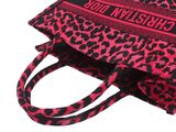 pink and black leopard print handbag with a black strap
