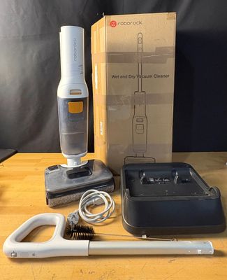 a box with a vacuum and a brush on a table
