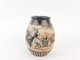a vase with a picture of a man riding a horse on it