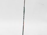 a sculpture of a stick on a black base with a red inscription on it