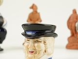 three figurines of a man with a top hat on