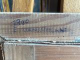 a close up of a piece of wood with writing on it