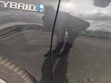 a reflection of a man on the side of a car