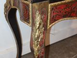 a small table with a red and gold design on it