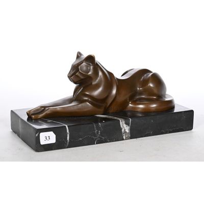 bronze sculpture of a cat laying on a black marble base