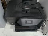 a printer sitting on top of a desk next to a printer