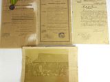 trois vieux papiers sont posés sur une table blanche