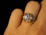 a close up of a person ' s hand with a ring on it