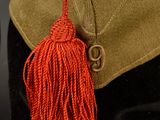 a hat with a red tassel on a mannequin head