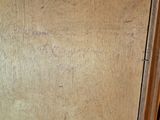 a wooden cabinet that has a brown door and a brown handle