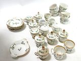 a lot of small dishes and cups on the table