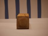 a small wooden block sitting on a white table