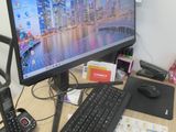 a computer desk with a keyboard, mouse, and a monitor
