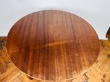 an image of a round wooden table on top of a wooden floor