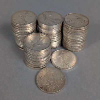 several stacks of silver coins sitting next to each other on a table