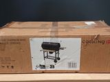 a cardboard box on a table with a grill on it