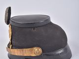 an old black hat with a gold buckle on the side of it