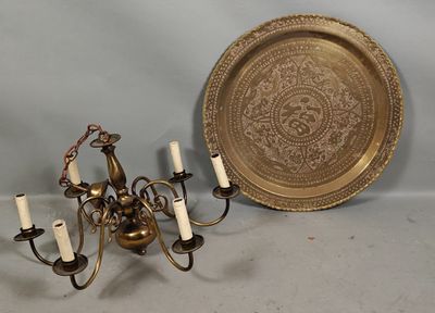 a gold plate and a chandelier with candles on it